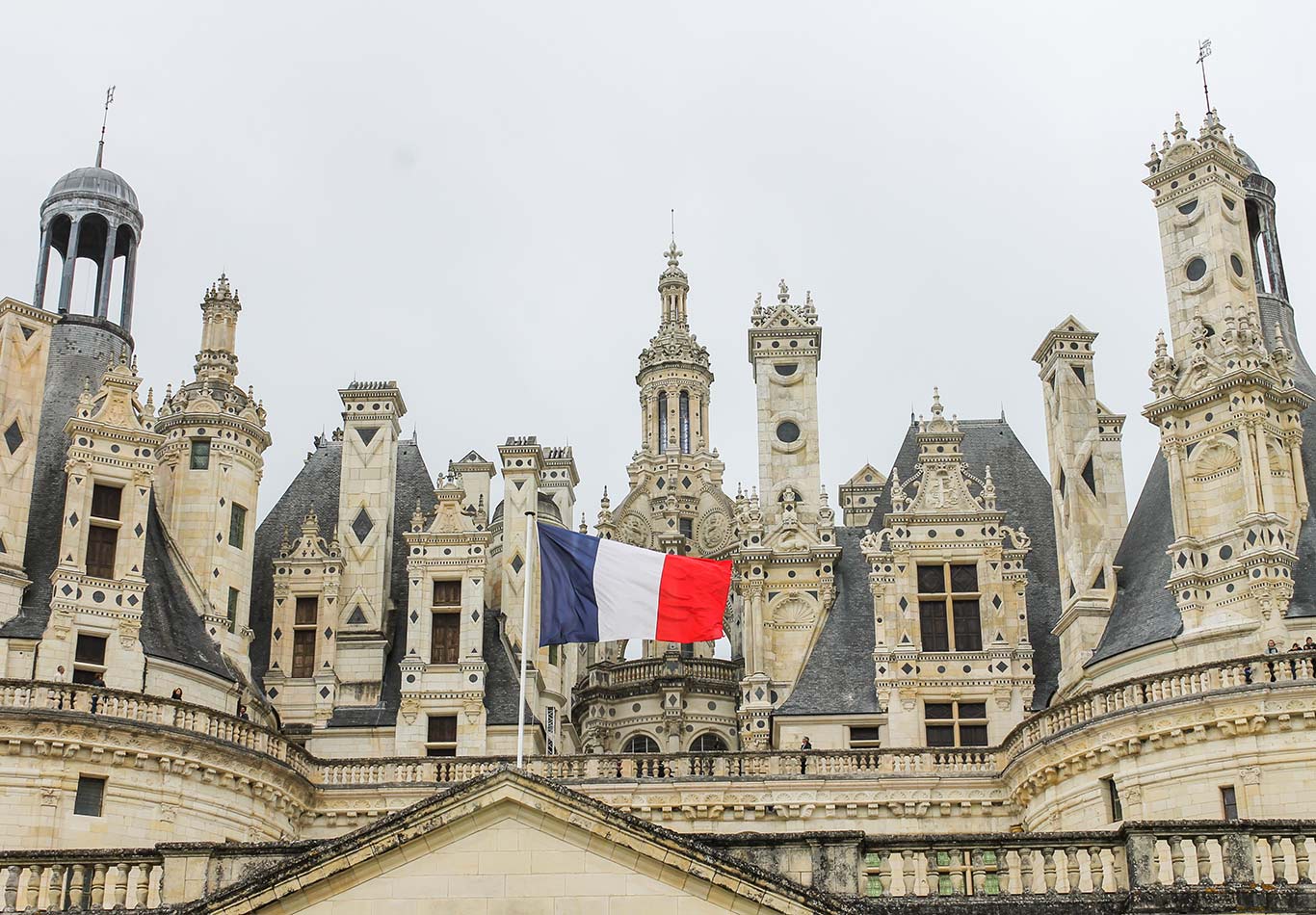 Spires of a castle and flag of France flying