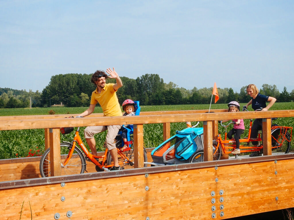 Family with children cycling in the Euganean Hills, Italy