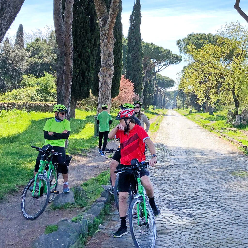 Two cyclists on a tree-lined road, cycling holiday in Italy
