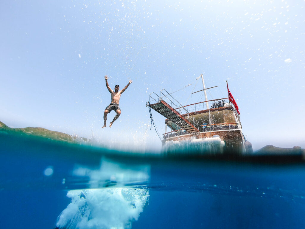 Jumping off a gulet into the crystal-clear waters of the Greek islands, sailing and cycling holiday Greece