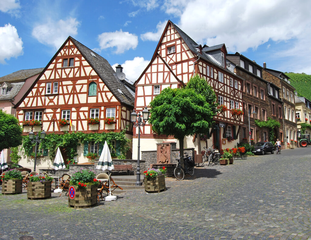 Traditional half-timbered houses on a cobblestone square in a Moselle valley village