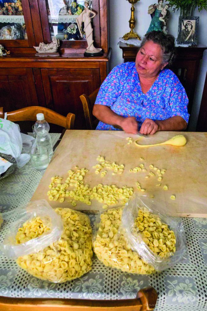A local woman hand-making orecchiette pasta in Salento